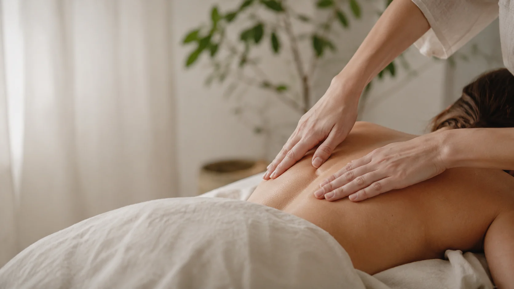 Relaxing massage therapy session with warm towels and gentle hands